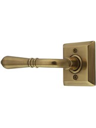 Quincy Rosette Door Set with Turino Levers with Left Hand Levers in Antique Brass.